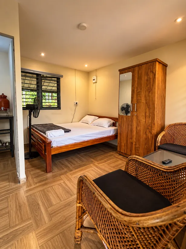 Bedroom with a queen bed and cane chairs